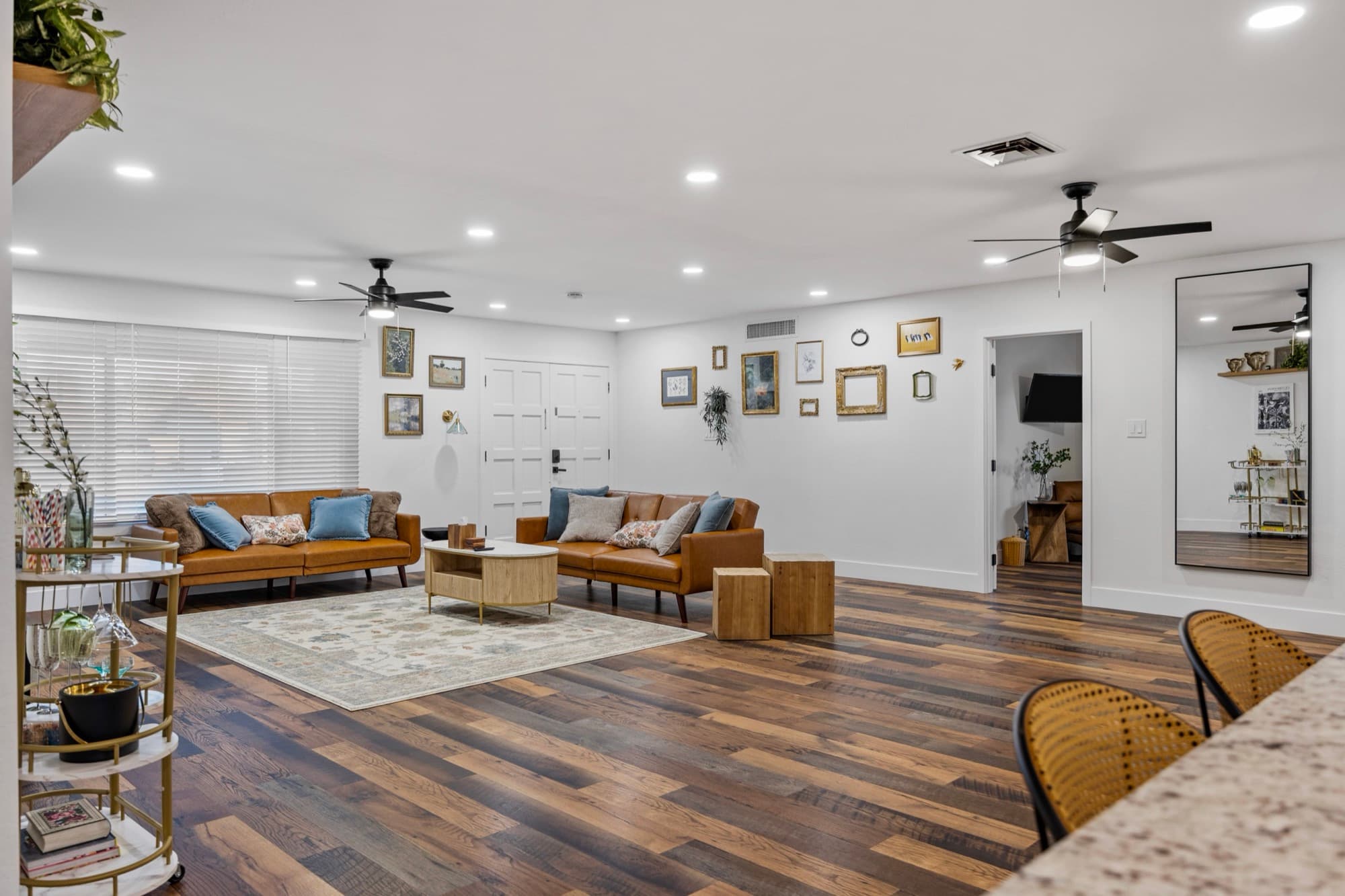 Open living and dining area with a gallery wall